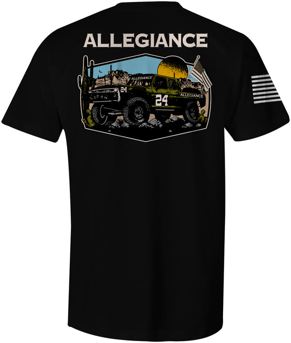 Back of Baja Classic Tee in black showcasing large graphic of an off-road truck set against a desert landscape with mountains, sunset, and American flag.