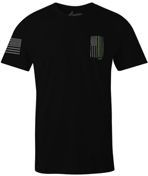 Black Allegiance Back the Green Tee featuring a small distressed black-and-gray American flag with a green line and monochrome flag sleeve print.