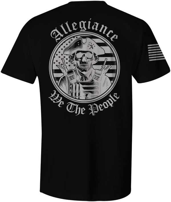 Large graphic of a skull-faced patriot in a tricorn hat and tactical gear with rifles, standing in front of a blacked-out American flag; 'Allegiance' arched above and 'We The People' curved below on the back of a black t-shirt