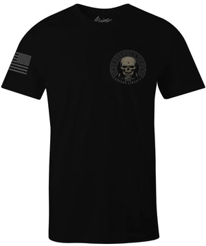 Front of Defender Tee in black with small chest graphic and American flag printed on the sleeve